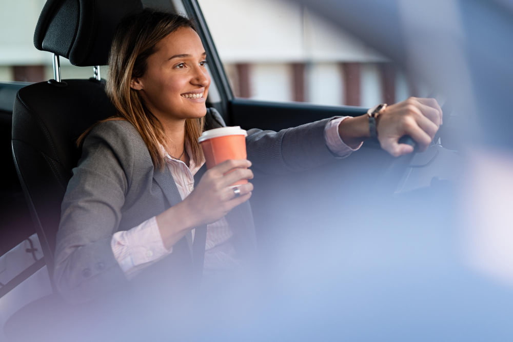 young-happy-businesswoman-with-coffee-go-driving-car (1)